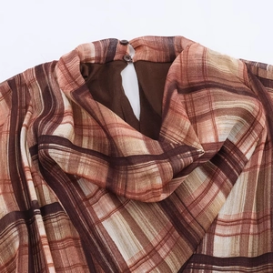 Brown plaid midi shirt dress with buttoned stand collar and lightweight fabric texture