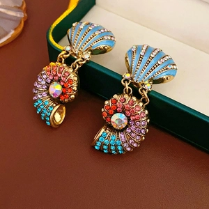 Detailed close-up of vintage shell earrings with colorful crystals and gold plating