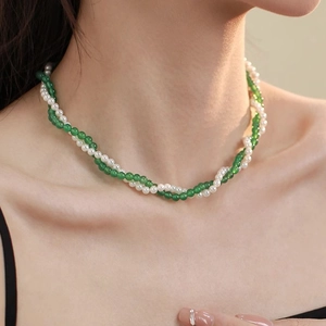 Detail of double-layer pearl and green agate beaded necklace with elegant twisted design