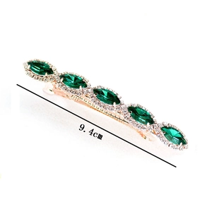 Macro detail of 9.4cm rose gold hair clip with green marquise stones and tiny crystals