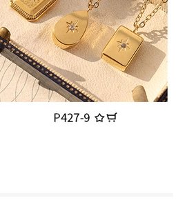 Detailed shot of gold-plated U-shaped wave rings with teardrop and rectangle charms