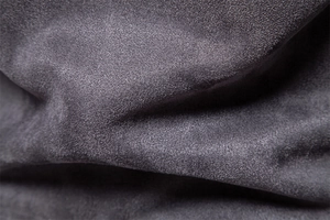 Detailed close-up of dark grey suede fabric texture for men's jackets and apparel