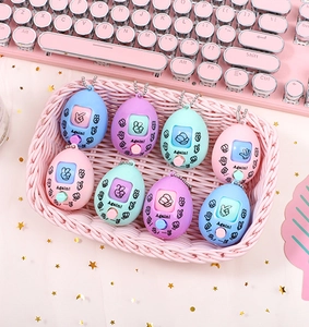 Close-up of egg-shaped rock paper scissors game keychains in various candy colors