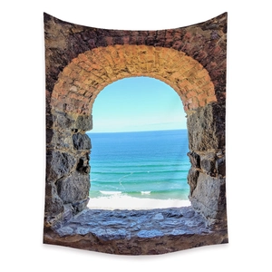 Detail of bohemian wall tapestry with stone arch window and ocean view scenery