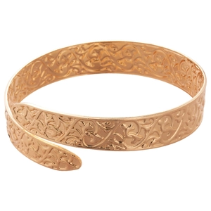 Vintage gold open cuff bracelet with intricate floral relief and a retro aesthetic