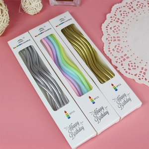 Close-up of three packs of curved birthday candles in gold, silver, and rainbow colors