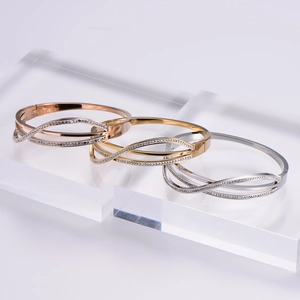 Sparkling crystal pavé crossover bangles in gold, rose gold and silver finishes