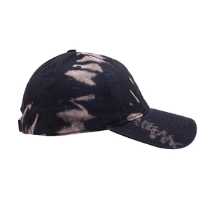 Detail of tie-dye baseball cap featuring black and white bleached patterns and stitching