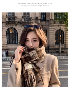 Detail shot of brown houndstooth warm scarf with fringe and woven GF. ideal brand label