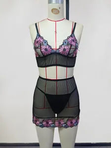 Detail of floral embroidery on sheer mesh lingerie set with bra and matching skirt