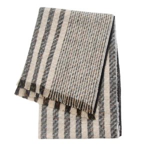 Detailed view of beige and black vertical striped woven scarf fabric texture