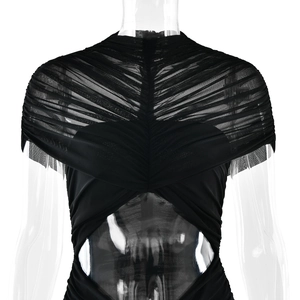 Detail of black evening gown featuring sheer mesh paneling and ruched waist cut-out