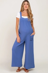 Detail of blue maternity overalls featuring cotton linen texture and adjustable straps