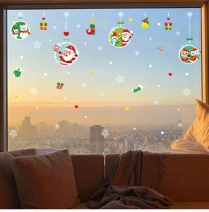 Christmas window stickers with Santa, snowman and reindeer on a glass pane at dusk