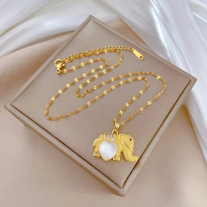 Elegant gold elephant necklace with heart-shaped white shell inlay on silk fabric
