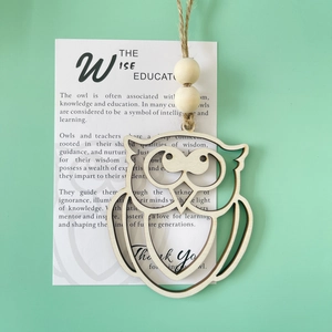 Detail of wooden owl pendant with rustic twine and an educational thank you card