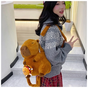 Cute Capybara plush backpack with burger pendant shown on model back for size scale