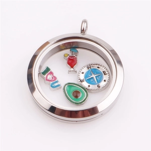 Detailed macro shot of a round silver locket with glass face and colorful enamel charms inside