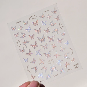 Detail of MS-483 nail stickers featuring holographic butterfly patterns and text art