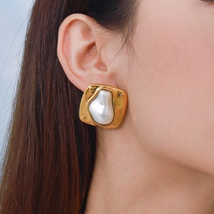 Chic gold irregular square earrings with large baroque pearl shown on a model