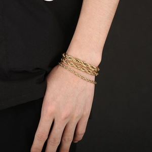 Detailed view of three gold twist rope bracelets in 4mm, 6mm, and 8mm widths on wrist