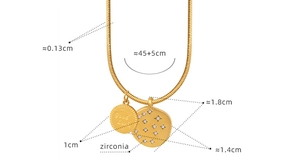 Detailed view of golden necklace with Good Luck coin pendant and zirconia charm size labels