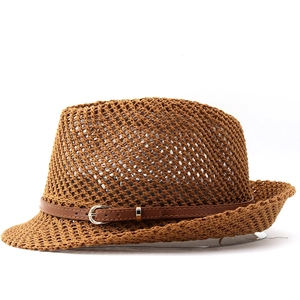 Detail of hollow knit straw cowboy hat featuring a leather band with metal buckle closure
