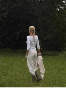 Vintage slim-fit off-shoulder top with long sleeves in white shown on a forest backdrop