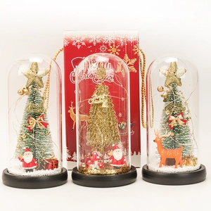 Detail of Christmas glass dome with LED tree, reindeer and festive red gift bag