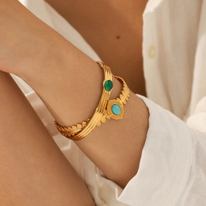 Vintage gold stainless steel bangles with green agate and turquoise in natural light