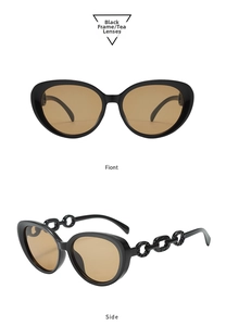 Detail of cat eye sunglasses with thick black frames and ornate chain-link temples
