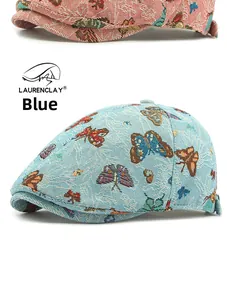 Detailed close-up of blue butterfly jacquard fabric on a retro style flat cap