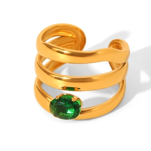 Detail view of multi-layer gold plated ring featuring a vibrant oval green gemstone