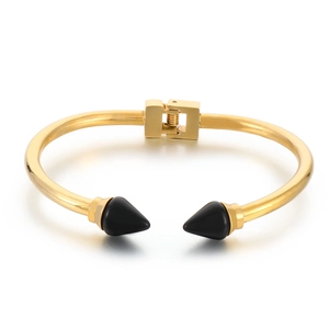 Gold stainless steel rivet bangle with black spike accents and polished metallic finish