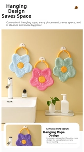 Close-up of soft floral coral velvet hand towels with hanging ropes in four colors