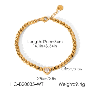 Macro shot of gold-plated stainless steel bead chain with a sparkling heart zircon pendant