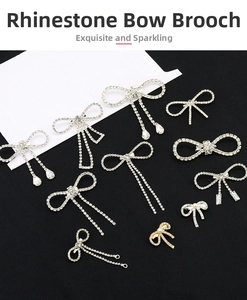 Detailed collection of silver rhinestone bow brooches with pearls and tassels