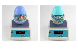 DIY assembly dinosaur egg toy showing exact weight on scale with rock texture shell
