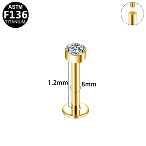 Detail of 1.2x8mm gold G23 titanium labret stud with internal thread and diamond top