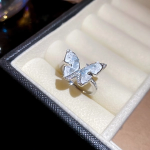 Detailed macro view of 14k gold-plated butterfly ring with blue opal wings and zircons