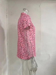 Detail of pink polo shirt with golf tee pattern on a side-view transparent mannequin