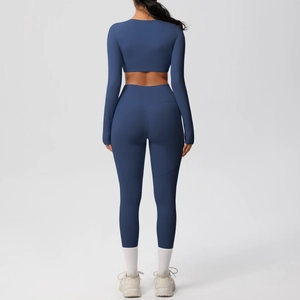 Detail view of seamless high-waist leggings and long-sleeve crop top back stitching
