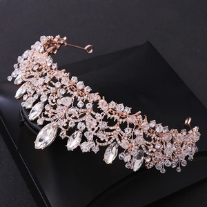 Detailed close-up of handmade gold bridal crown with crystal beads and pear-shaped gems
