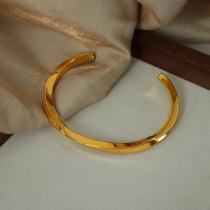 Vintage style gold-plated titanium steel twisted open bangle with minimalist geometric design