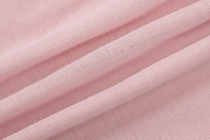 Macro shot of pink knitted fabric texture showing soft and lightweight fibers