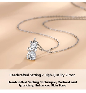 Macro view of handmade cat pendant featuring sparkling round and teardrop zircons