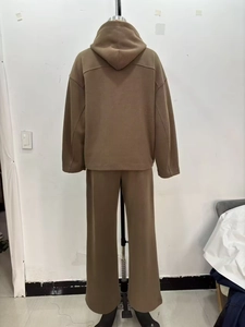 Back view of brown hooded sweatshirt and wide-leg trousers set on a mannequin