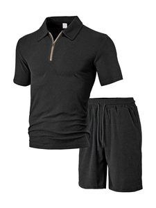 Detail of men's black knit polo set showing textured herringbone fabric and zip collar