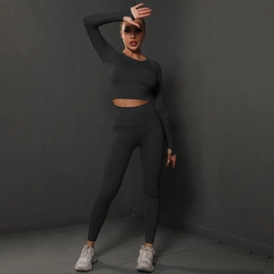 Detail of black seamless yoga set featuring thumb holes on sleeves and high waist fit