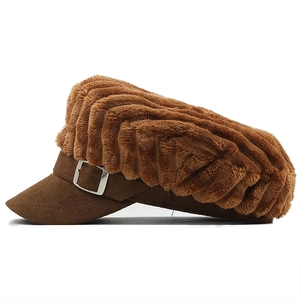 Close-up of dark brown plush newsboy hat with ribbed faux fur texture and silver buckle